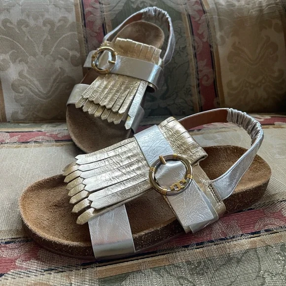 Tory Burch Multi-Logo Kiltie Sandal - Silver / Spark Gold / Natural. Size 7